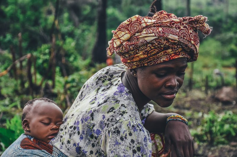 African mother carrying child - wisdom passed through generations